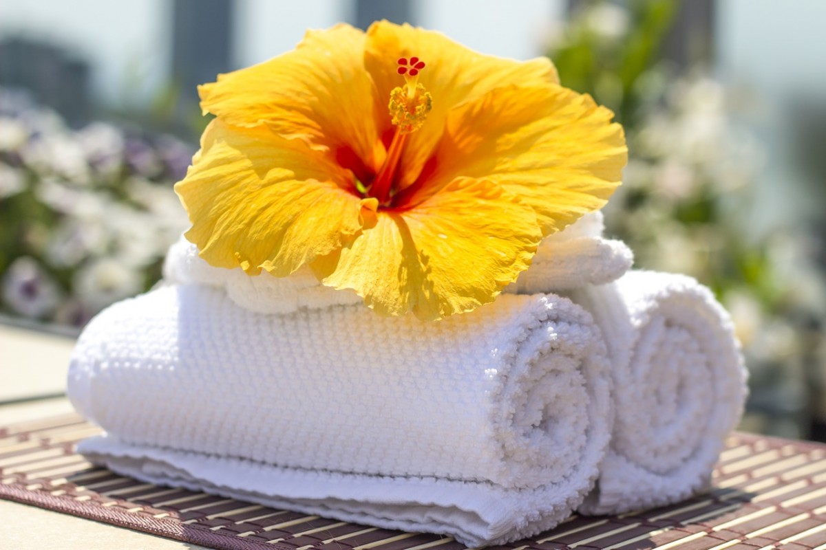 Hibiscus flower on towels at a luxury resort