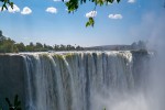 A great scale water fall beyond trees at Victoria Falls banner iStock 1350942748