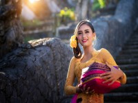 Bali Lady in Traditional dress walk in old temple indonesia iStock 1257356852 1