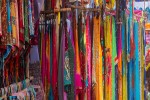 Indian bazaar shopping benches with colorful saris and dresses Day Market Anjuna Goa banner iStock 1333182454
