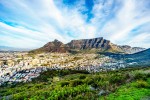 Sun setting over Cape Town Table Mountain Devils Peak Lions Head and the Twelve Apostles. Viewed from the road to Signal Hill at Cape Town South Africa shutterstock 704365027