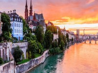 Basel Switzerland. Old town with Munster cathedral on the Rhine river at sunsetBanner . iStock 869122798