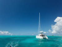 Close up of single catamaran with tall white mast in tropical waters in the British Virgin Islands iStock 462466127