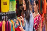 Happy mother and daughter looking and buying clothes together from outdoor street market of Delhi India at day time. iStock 1212679579