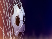 Soccer ball hit the netsuccess goal concept on stadium banner iStock 960757064