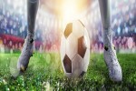 Soccer player ready to kick the soccerball at the illuminated stadium during the match banner iStock 1154664311