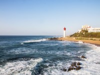The Lighthouse at Umhlanga overlooked by Buildings stock photo. 1920x1080
