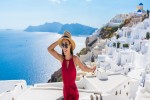 Travel Tourist Happy Woman Running Stairs Santorini Greek Islands Greece Europe. Girl on summer vacation visiting famous tourist destination having fun smiling in Oia banner