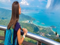 Woman traveler viewpoint on Langkawi island Malaysia banner iStock 1347171682
