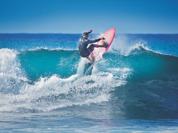 a man surfing the waves on a kenya beach